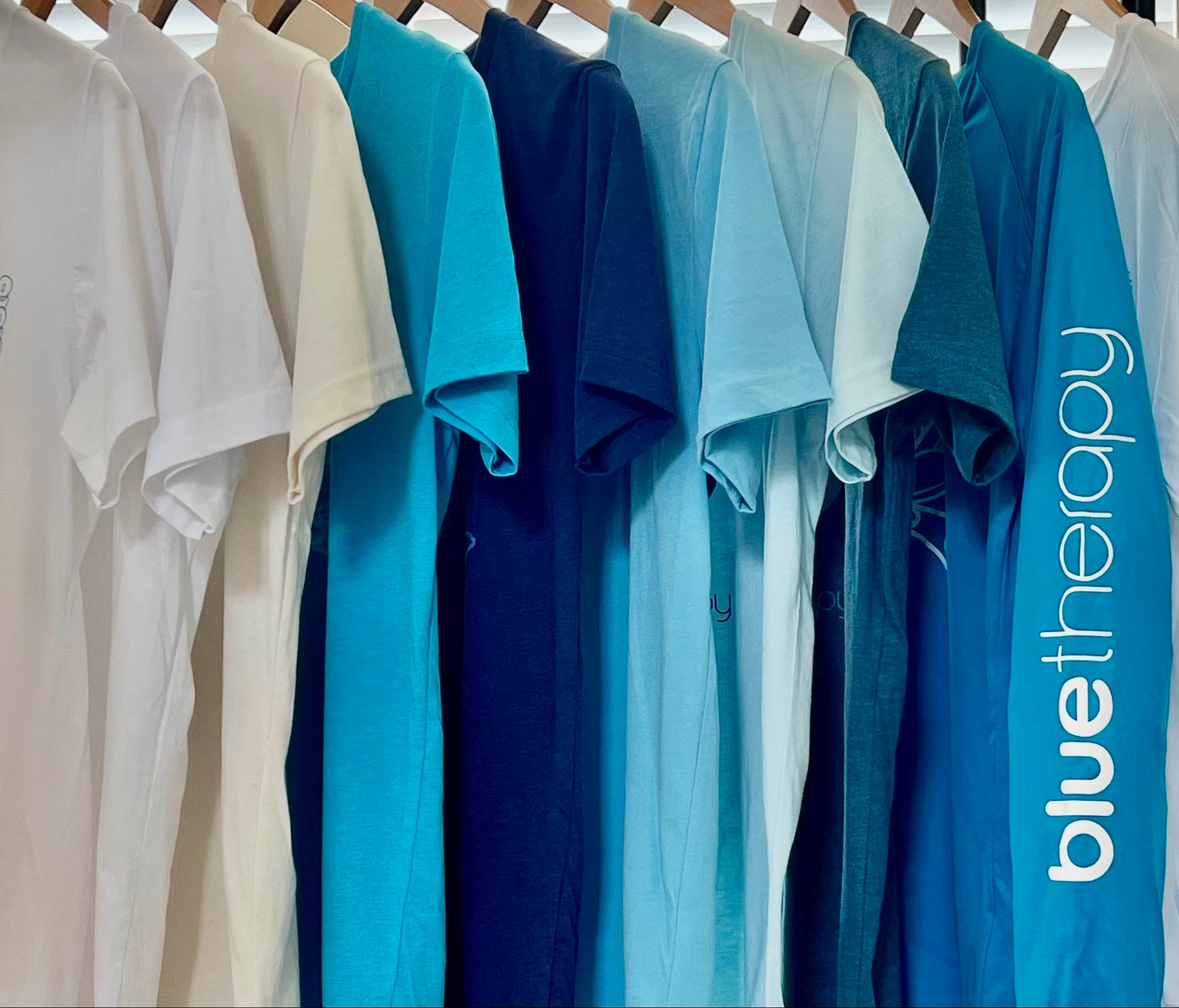 BlueTherapy t-shirt collection spectrum: variety of tees, tanks & crops with whale shark, zen diver, wave & ocean graphics in multiple colors and styles