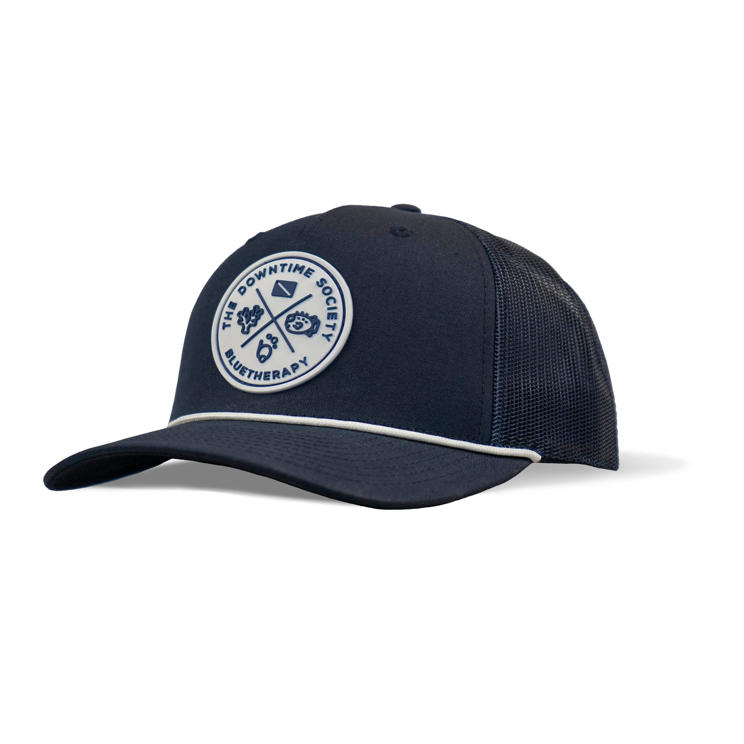 Front 3/4 view of BlueTherapy Downtime Society navy blue rope trucker hat with a white vinyl patch on the front, featuring a curved brim and an adjustable snap-back.