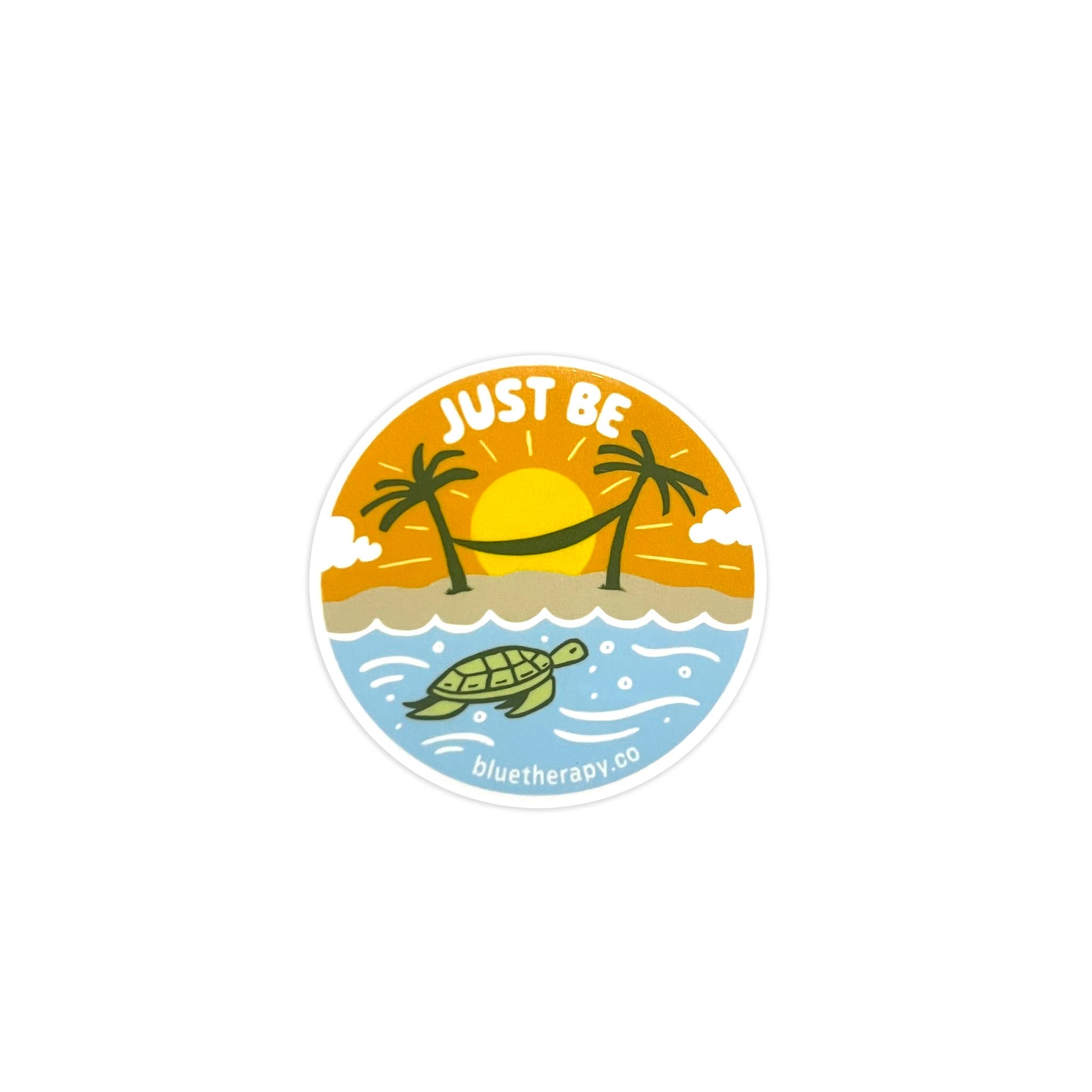 Round die-cut vinyl sticker with a 'Just Be' text and a turtle graphic, designed with a sun and palm trees in the background and BlueTherapy.co website address.
