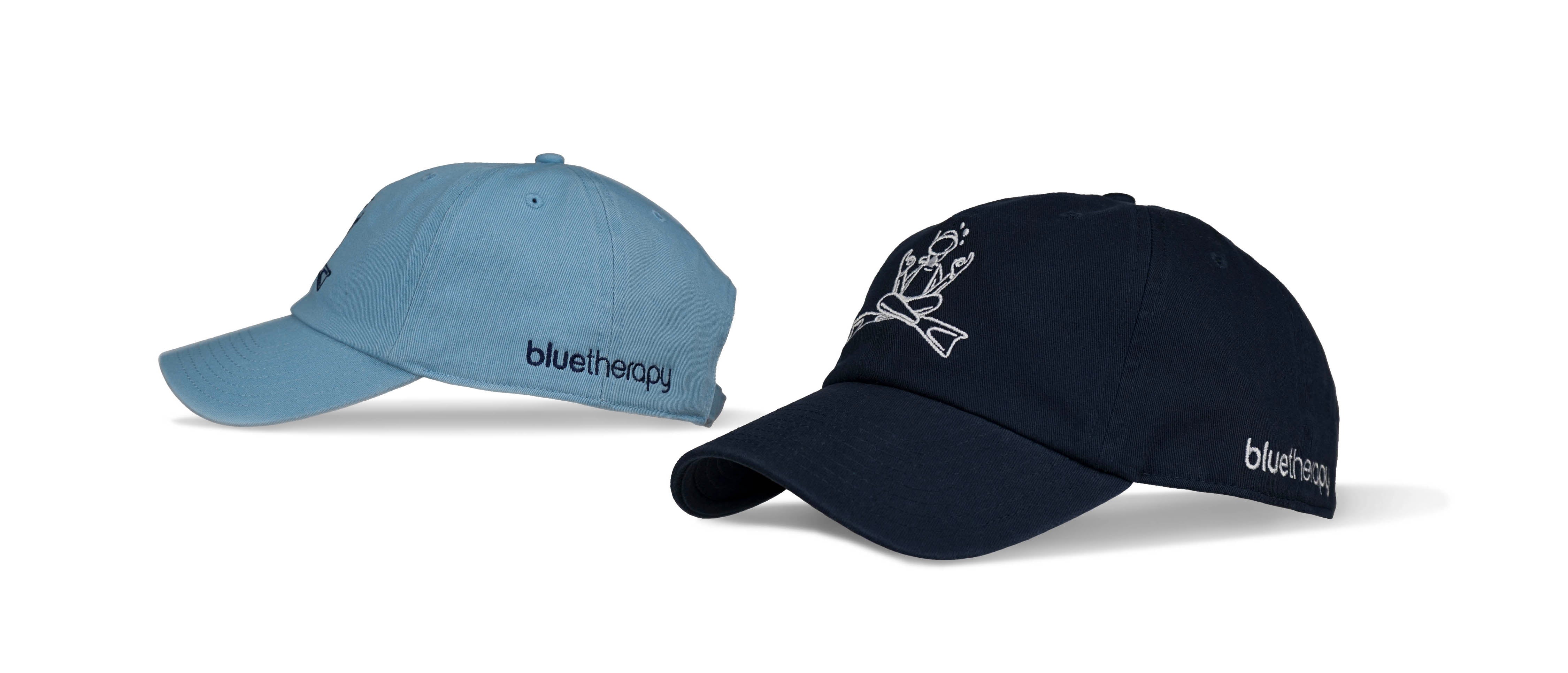 Studio shot of BlueTherapy Zen dad hats on white background, close-up of navy and light blue caps featuring white embroidered zen diver graphic and brand logo